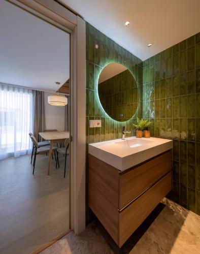 a bathroom with a sink and a mirror at Apartamentos Turísticos de Soria Centro NF in Soria