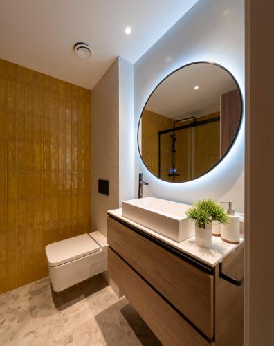 a bathroom with a sink and a mirror at Apartamentos Turísticos de Soria Centro NF in Soria