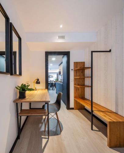 a dining room with a table and a bench at Apartamentos Turísticos de Soria Centro NF in Soria