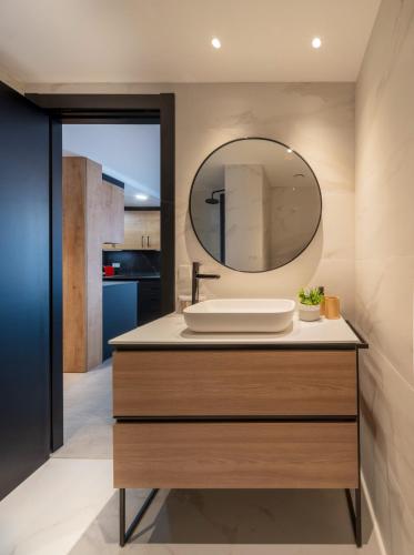 a bathroom with a sink and a mirror at Apartamentos Turísticos de Soria Centro NF in Soria