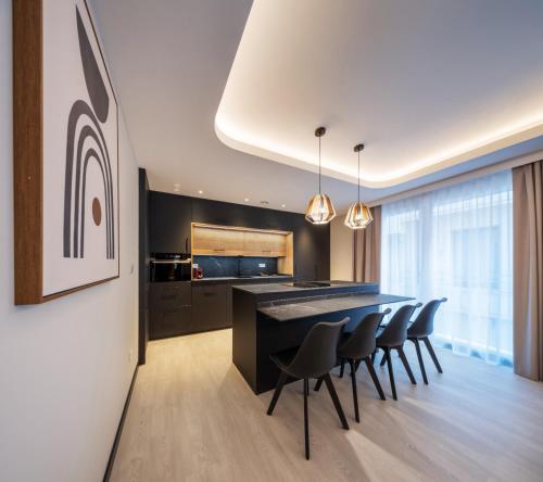 a kitchen with a dining table and chairs at Apartamentos Turísticos de Soria Centro NF in Soria