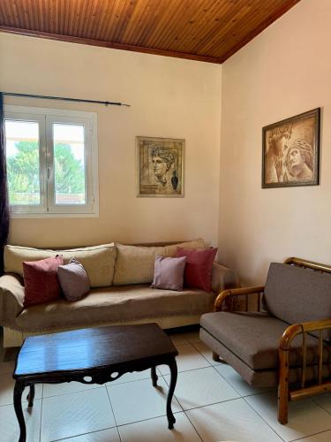 a living room with a couch and a table at Evilion Ktima Argyropoulou in Katarrákhion