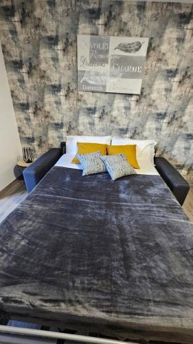 un lit dans une chambre avec deux oreillers dessus dans l'établissement studio 5min airport Roissy CDG Charles de Gaulle, au Mesnil-Amelot