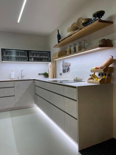 a kitchen with white cabinets and a white counter top at U NÁS DOMA v LUŽICÍCH in Lužice