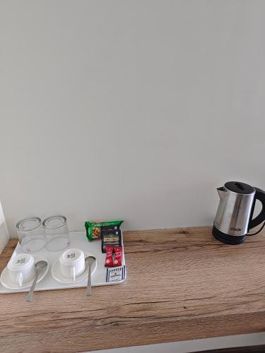 a counter top with a coffee pot and a cup at Lamahatta Clouds Hotel & Restaurant in Takdāh