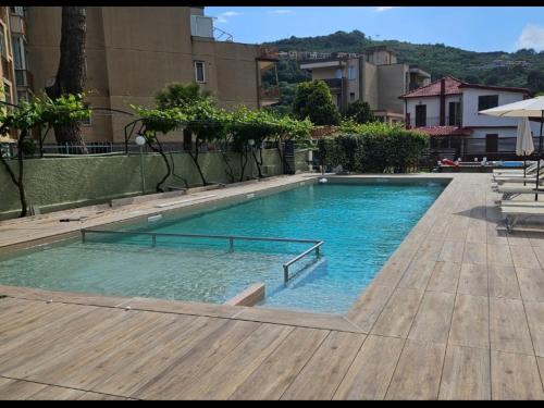 a swimming pool with blue water in a building at Holiday Gufetto in Pietra Ligure