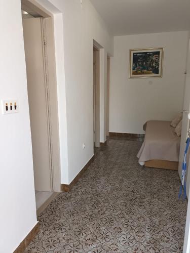 a hotel room with a bed and a hallway at Apartmani Dajana in Primošten