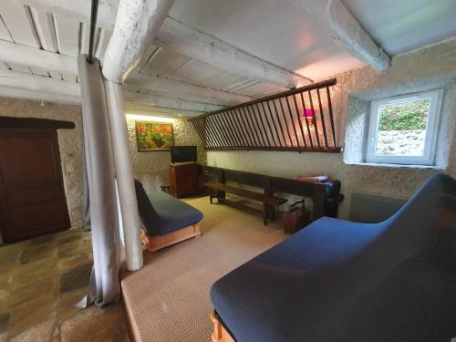 a living room with a couch and a piano at Gîte des Ailes in Vorey