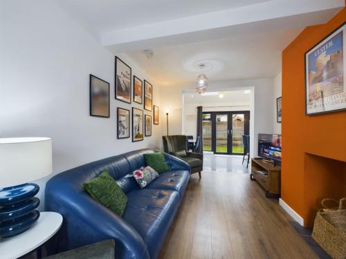 a living room with a blue leather couch at Marvelous Millar Street in Belfast
