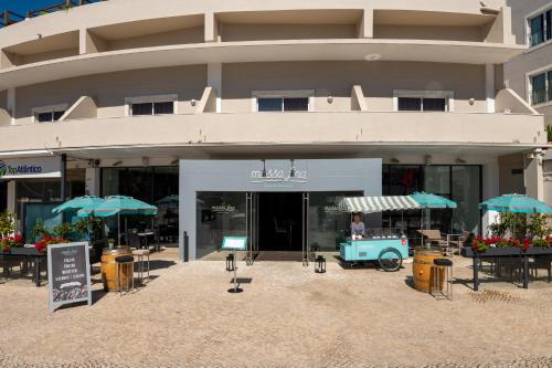 a building with an old car in front of it at Vila Galé Estoril in Estoril