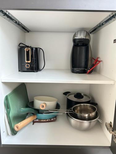 a shelf with various kitchen utensils in a refrigerator at Stay and Sleep in Leeuwarden