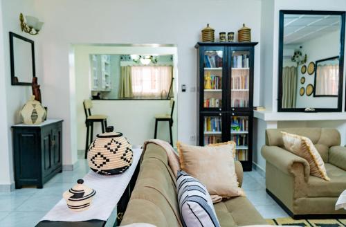 a living room with a couch and a table at Blue Veil Villa Hotel in Kigali