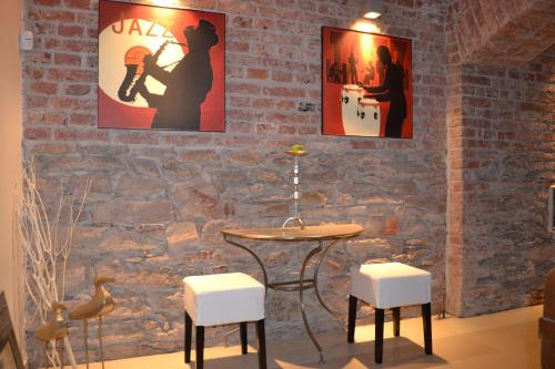 a room with a table and stools and posters at VILLA ANNA in Cerny Dul