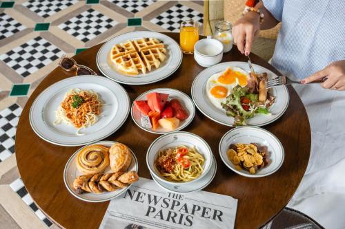 a wooden table with plates of food on it at Sugar Marina Resort-LAGOON-Villas, Naiyang Beach in Nai Yang Beach