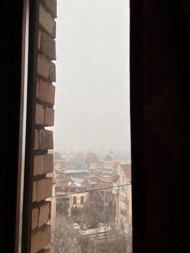 a view of a city from a window at Hotel Dambovita in Târgovişte