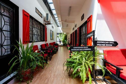 a hallway with chairs and plants in a building at Blue Veil Villa Hotel in Kigali