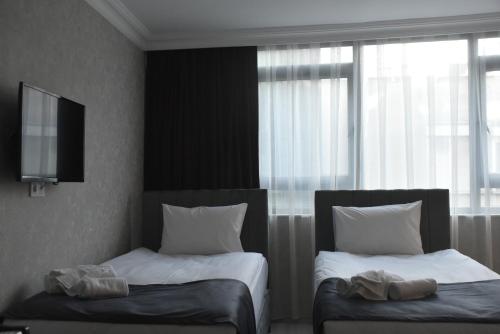 Ένα ή περισσότερα κρεβάτια σε δωμάτιο στο Palmera City Hotel