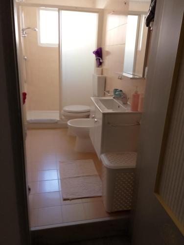a bathroom with a sink and a toilet and a shower at Affittacamere Casa Chiara in SantʼAntìoco