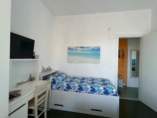 a bedroom with a bed and a desk and a television at Oasi Serena in Finale Ligure