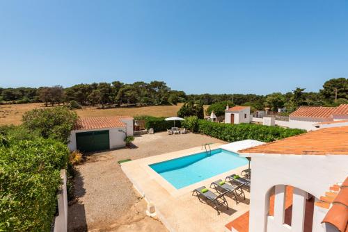 an external view of a villa with a swimming pool at Villa Xaloc in Port d'Addaia