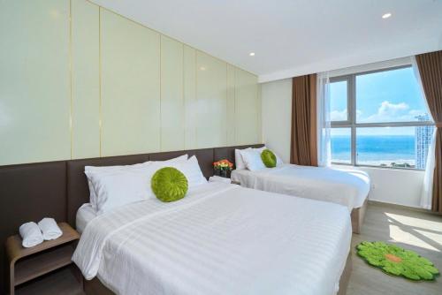 a hotel room with two beds and a large window at T-Plantino - Căn hộ Codotel The Sóng 5 Sao - Free swimmingpool, Gym, Sauna in Vung Tau