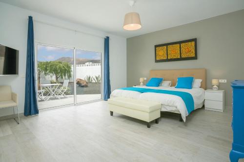 a bedroom with a bed and a view of a patio at The View in Tías
