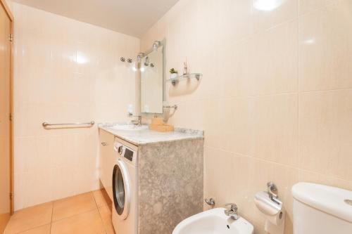 a bathroom with a washing machine and a sink at Apartamento En Canet in Canet de Berenguer