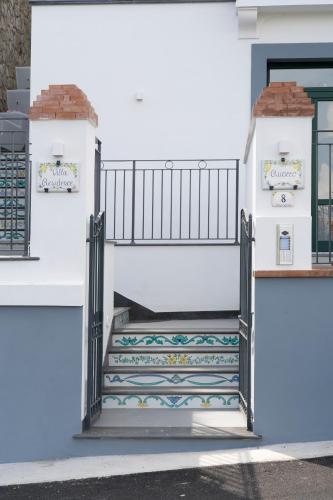 an entrance to a white building with a stairway at Suites in the Amalfi Coast - GuestHouse with Terrace near Amalfi - Breathtaking View of Ravello in Scala