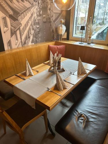 a wooden table in a restaurant with a table sidx sidx sidx at Landgasthof Hirschen in Hohenems