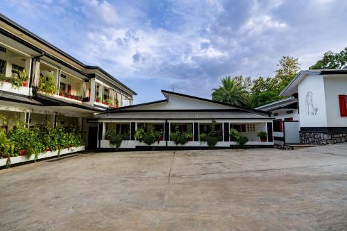 an empty parking lot in front of a building at Blue Veil Villa Hotel in Kigali