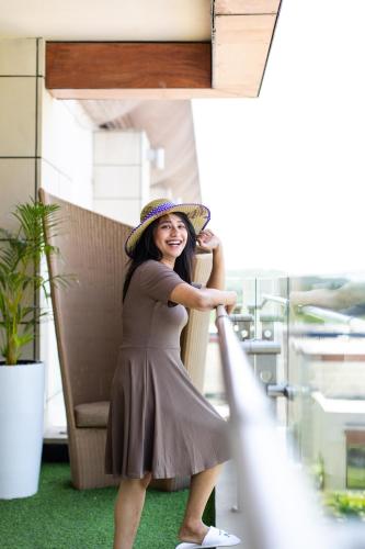 a woman wearing a hat standing in a chair at Novotel Hyderabad Airport in Hyderabad