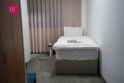 a hospital room with a bed and a table at Central Hotel, Fitness and Spa in Vinica