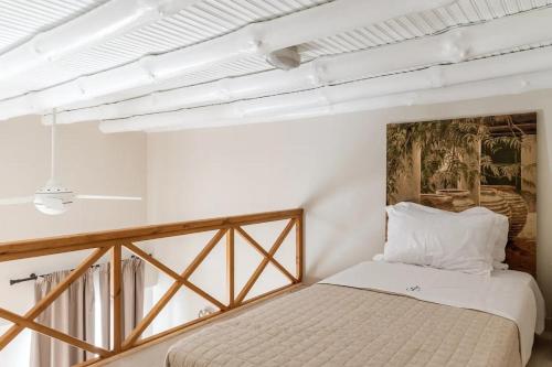 a bedroom with a bed and a painting on the wall at Villa Eleni - At the Top! in Apróvaton