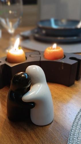 a pair of animal figurines on a table with candles at Tiny House GOČ in Goč