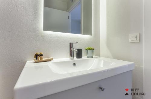 a white sink in a bathroom with a mirror at Antonio Lopez en Madrid in Madrid