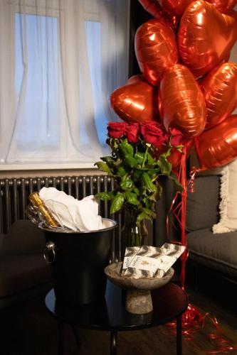 a table with a bunch of balloons and a vase at Exeter Hotel in Reykjavík