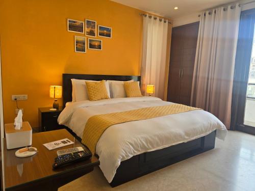 a bedroom with a large bed and a desk with a bed sidx sidx at Two Green Park in New Delhi