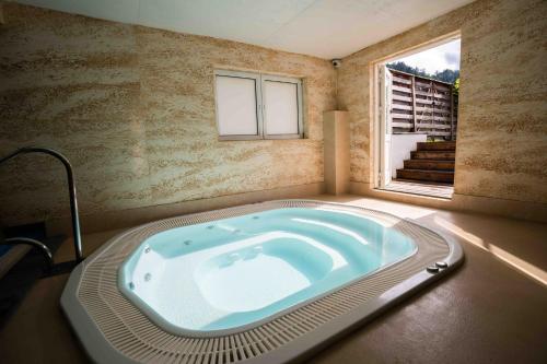 a large bath tub in a room with a window at Obidza 438 chata w górach in Obidza