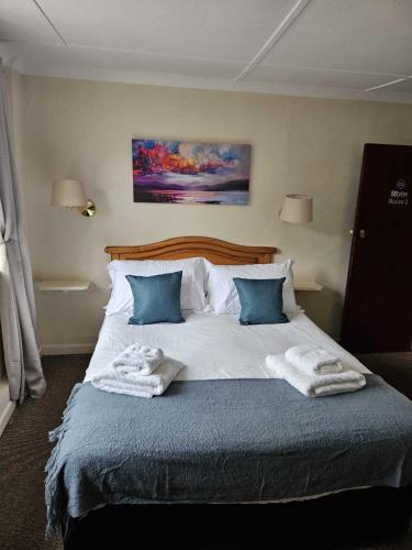 a bedroom with a large bed with towels on it at The Barford Inn in Salisbury