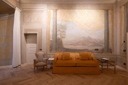a living room with a couch and a painting on the wall at Palazzo Doni by Florence Art Apartments in Florence