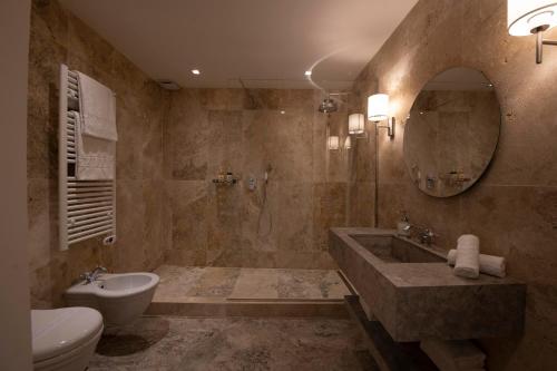 a bathroom with a sink and a toilet and a mirror at Palazzo Doni by Florence Art Apartments in Florence