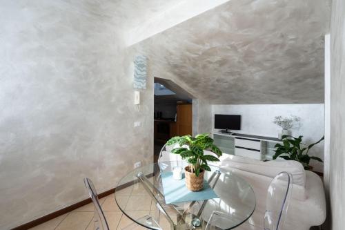 a living room with a table and a couch at Maison Mia in Parma