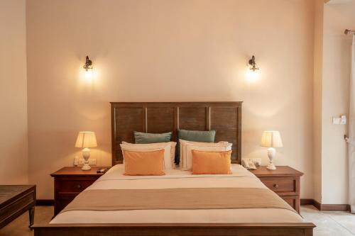 a bedroom with a large bed with two lamps at Heritage Boutique by Seven Angels in Kandy