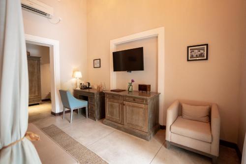 a room with a desk with a television and a chair at Heritage Boutique by Seven Angels in Kandy