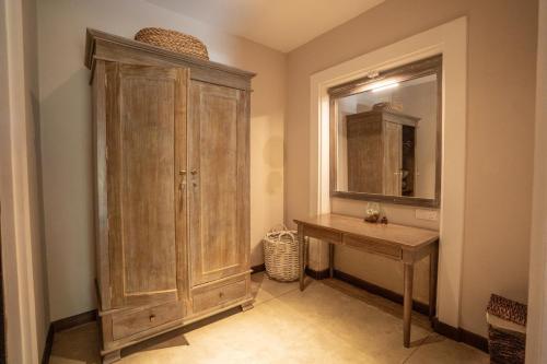 a bathroom with a wooden cabinet and a sink at Heritage Boutique by Seven Angels in Kandy