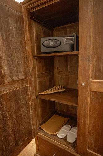 a cupboard with a router and a box in it at Clodagh Manor House by Seven Angels in Matale