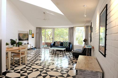 a living room with a black and white checkered floor at El Arbol by Da Alohas Luxury 2BHK suite Candolim in Nerul