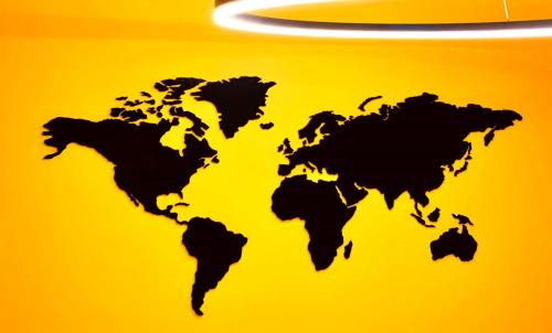 a black map of the world on a yellow background at Casa Gaea Stay in Braga