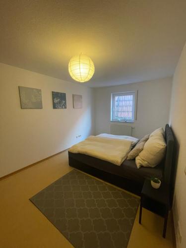 a bedroom with a bed and a light on the ceiling at Ferienwohnung im Herzen von Walldürn in Walldürn