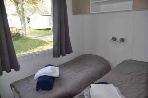 Ce lit se trouve dans un dortoir doté d'une fenêtre et d'un lit sidx sidx. dans l'établissement Camping 4 étoiles - Piscine - eec0hi, à Névez